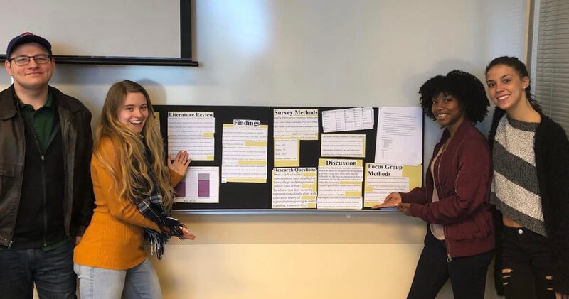 Research group presenting poster